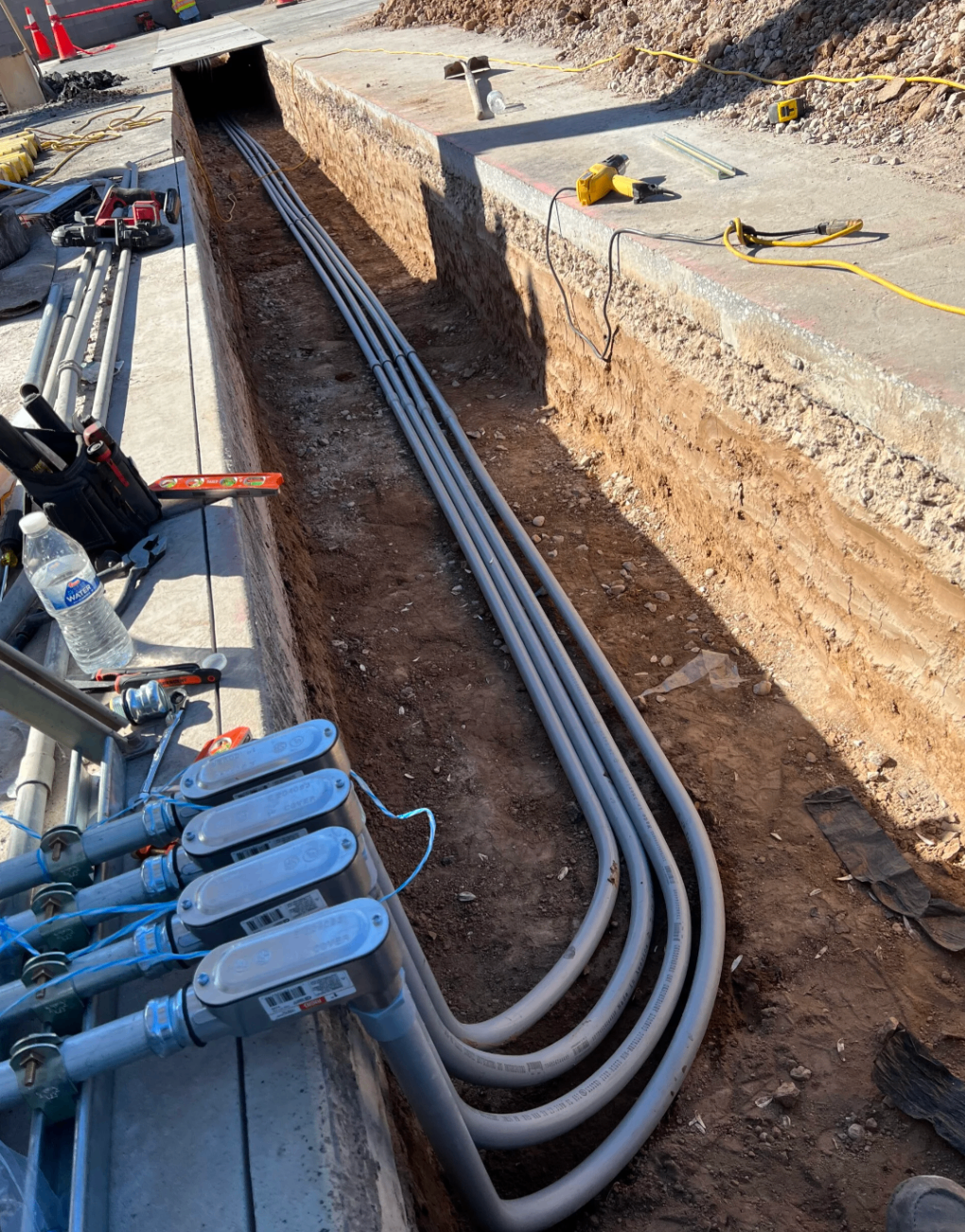 Electrical conduit installed in an underground trench on a jobsite